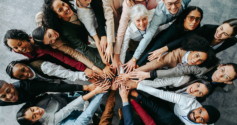 Group of People in Circle with Hands all together 