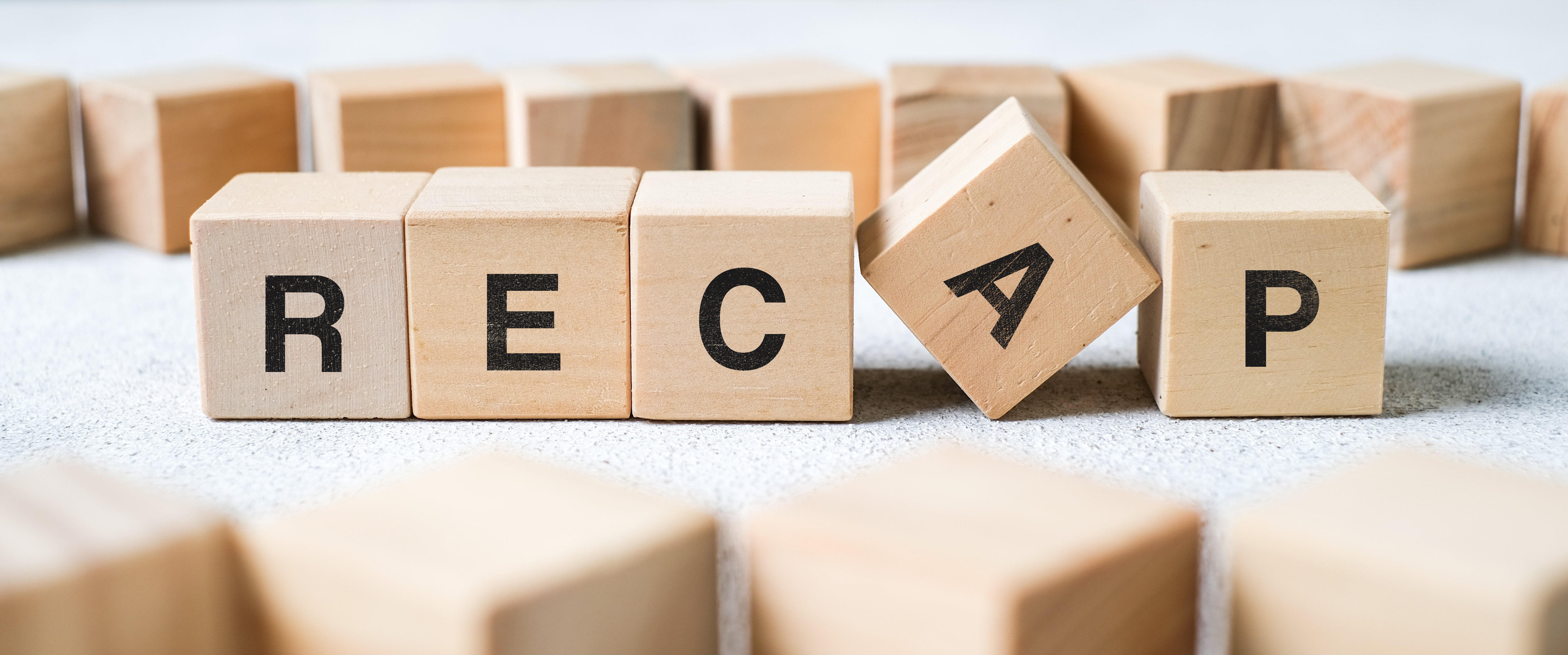 photo of the word recap spelled out in wooden blocks