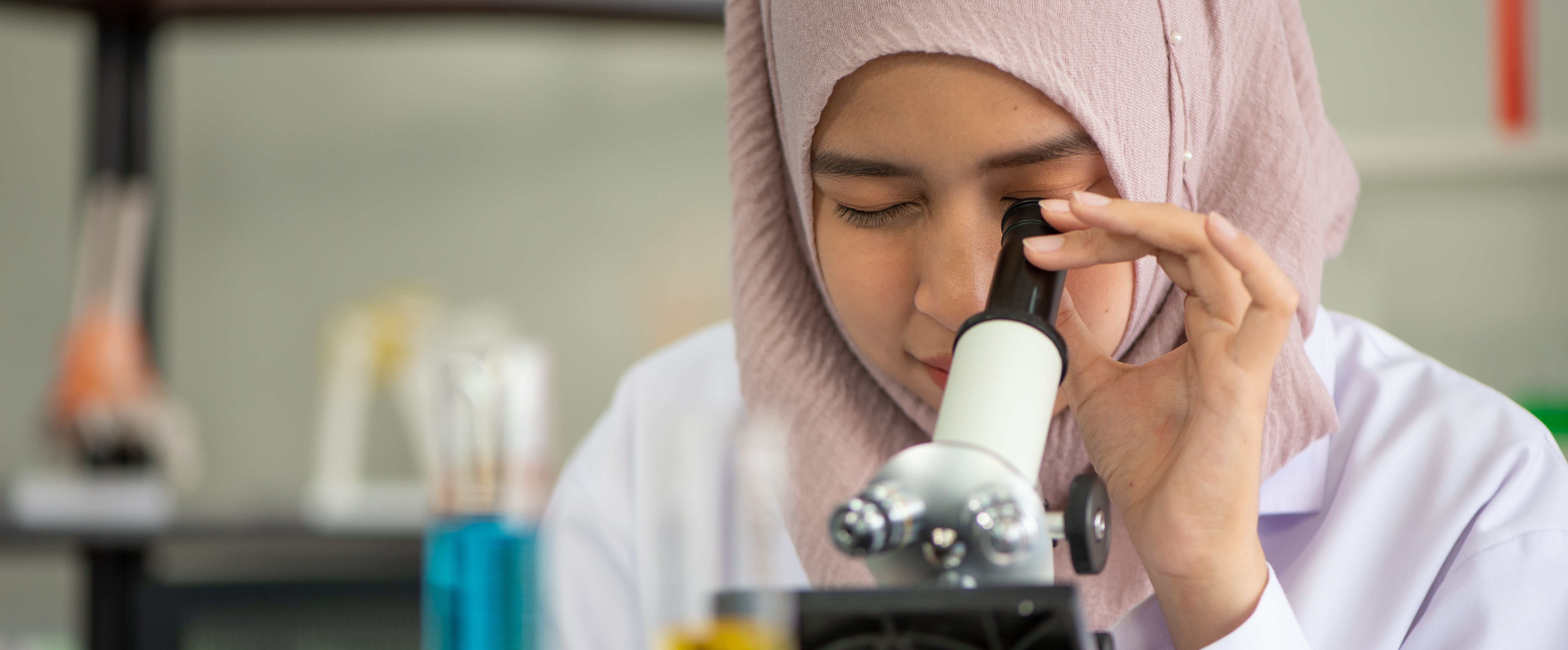 Girl looking through microscope