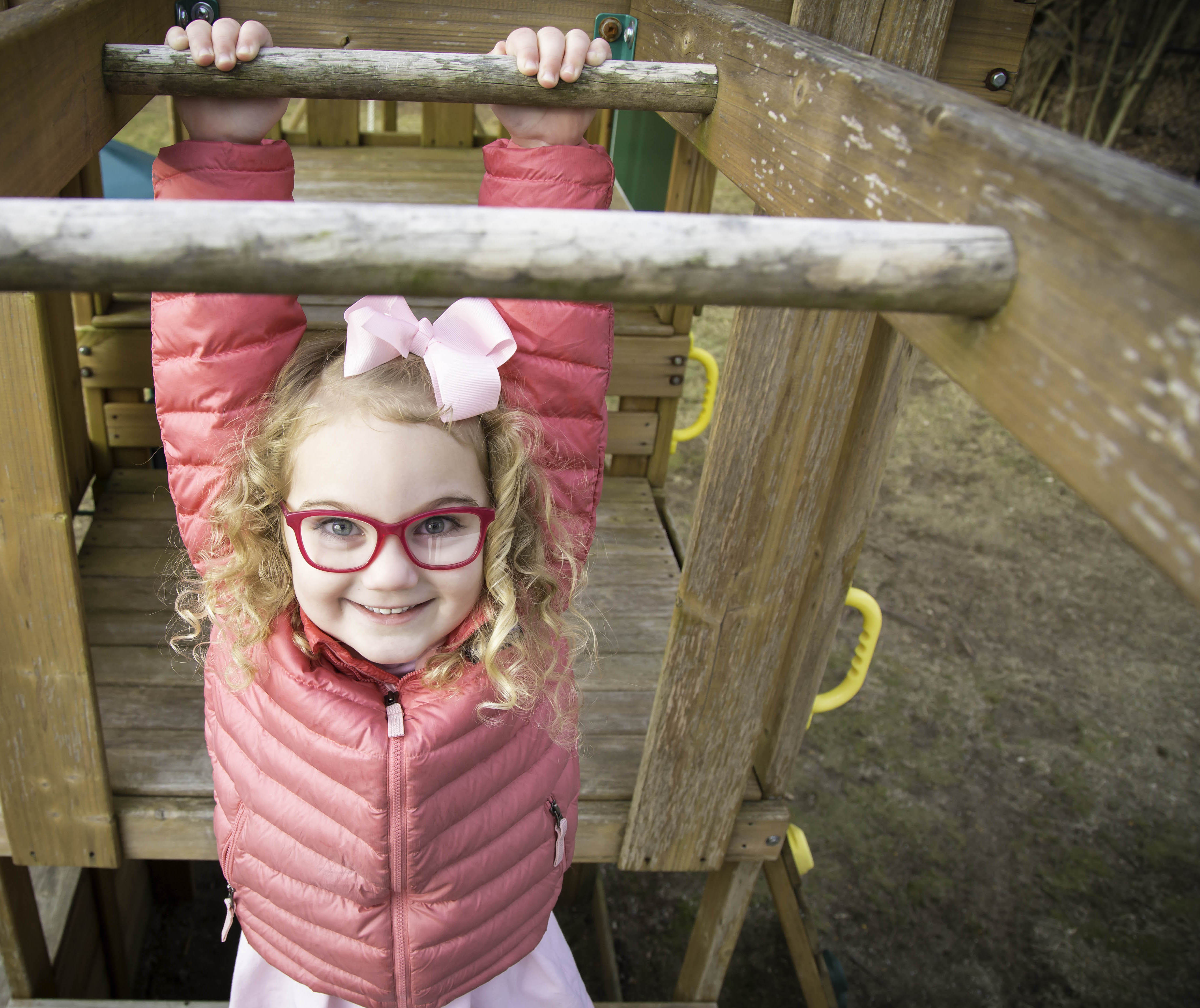 Girl Playing on Monkey Bars