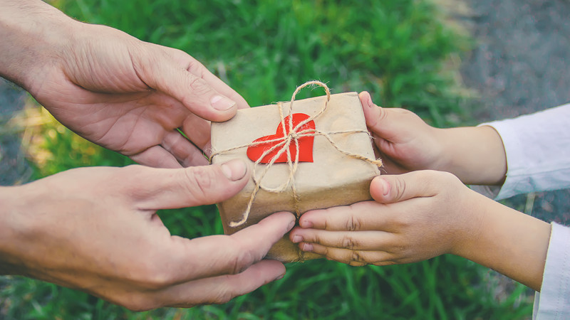 Adult Giving Child a Gift