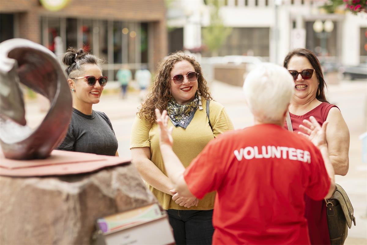 An AARP volunteer talks with a group of women.