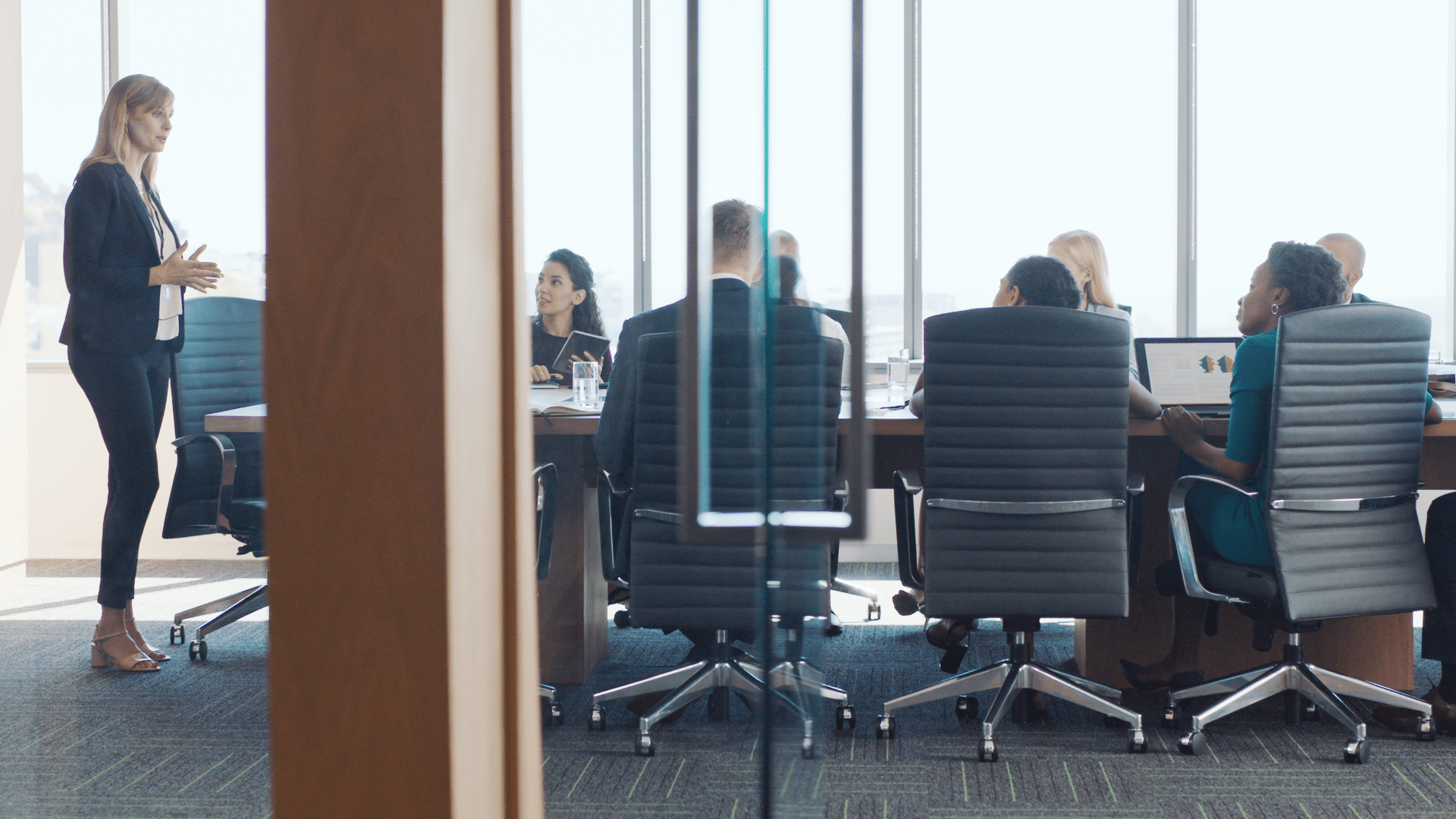 Business professionals leading a meeting in a conference room.