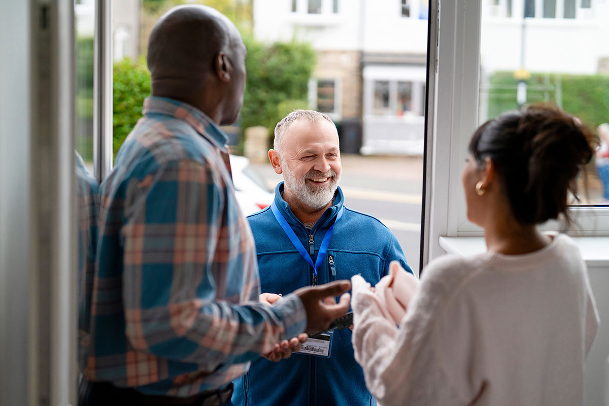 HVAC service technician talking with a customer during a service call