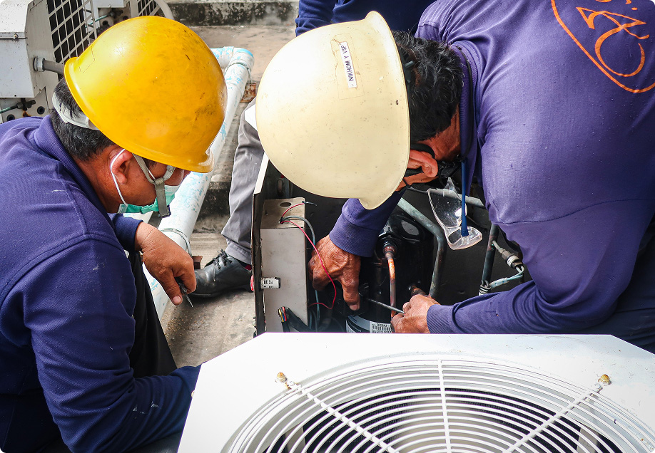 HVAC technicians servicing a unit