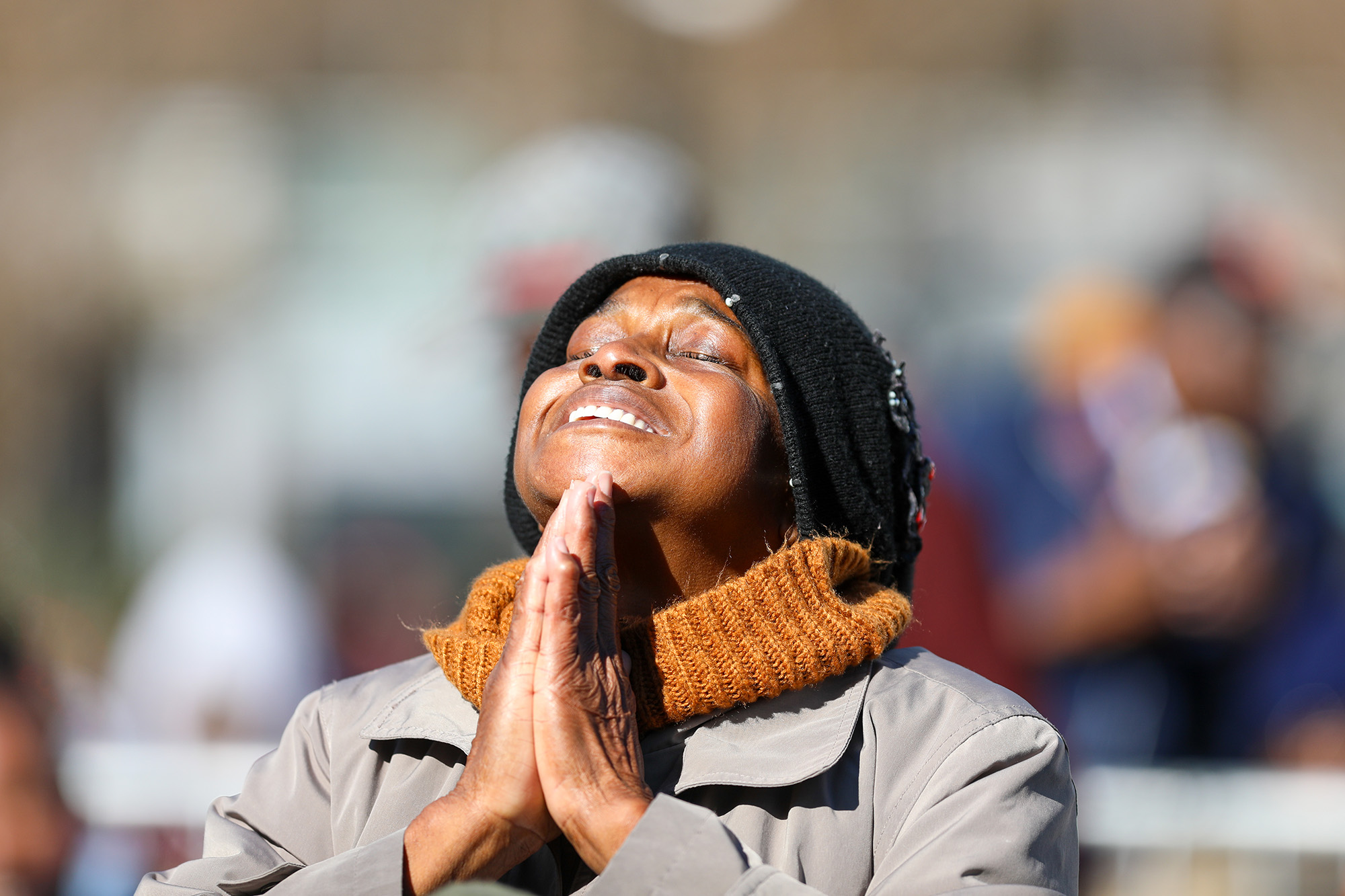 A woman closes her eyes in prayer during King Day