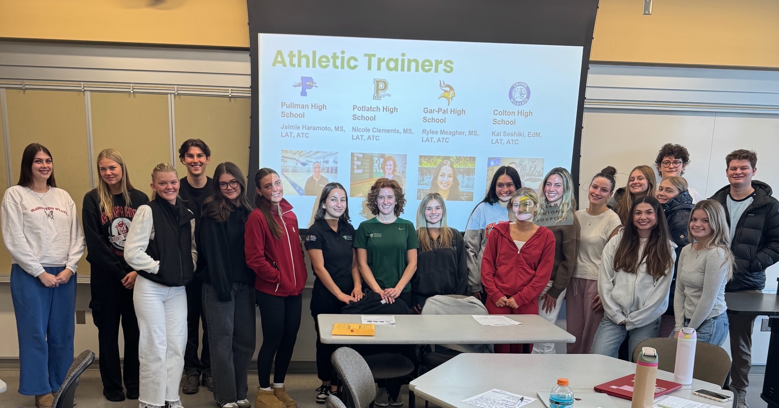 A group of people standing in front of a large projector screen

AI-generated content may be incorrect.