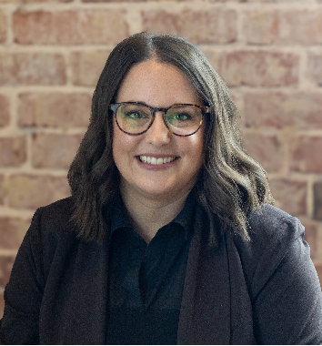 A person wearing glasses and smiling

AI-generated content may be incorrect.