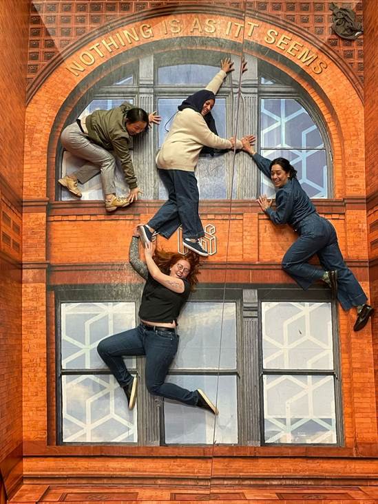 A group of people climbing on a building

AI-generated content may be incorrect.