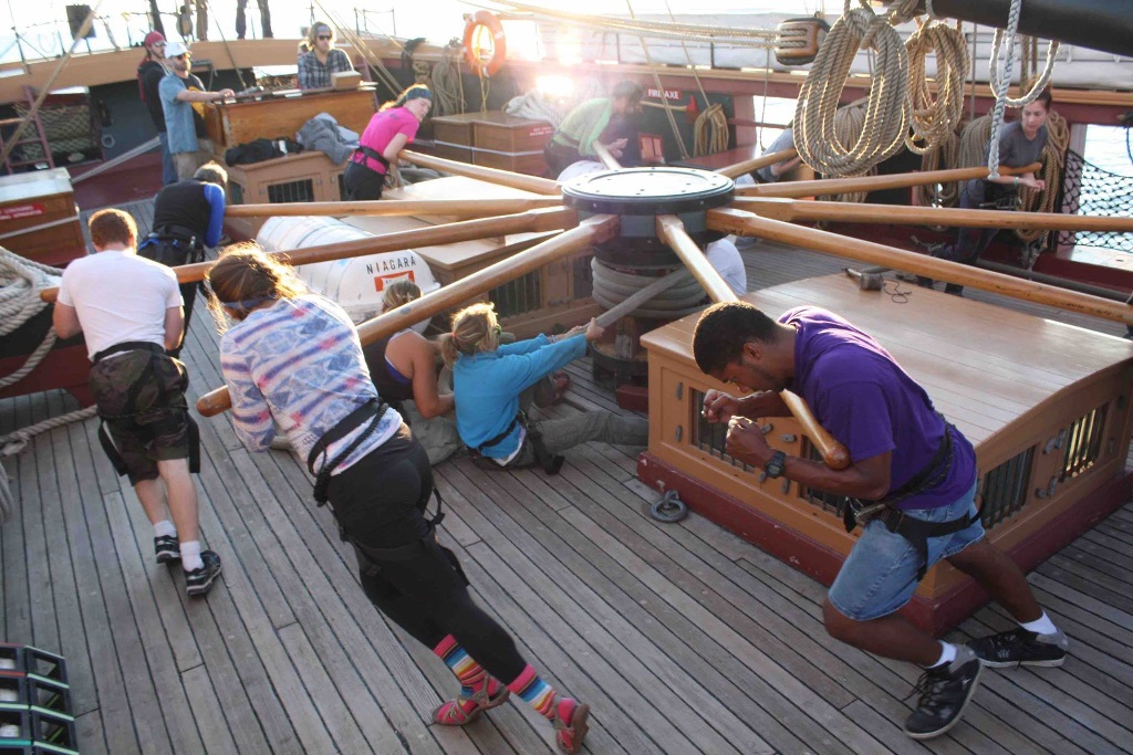 Williams-Mystic students work together to haul up USS NIAGARA's anchor using a capstan.
