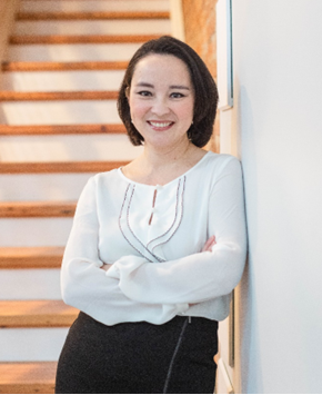 A person leaning against a wall

Description automatically generated