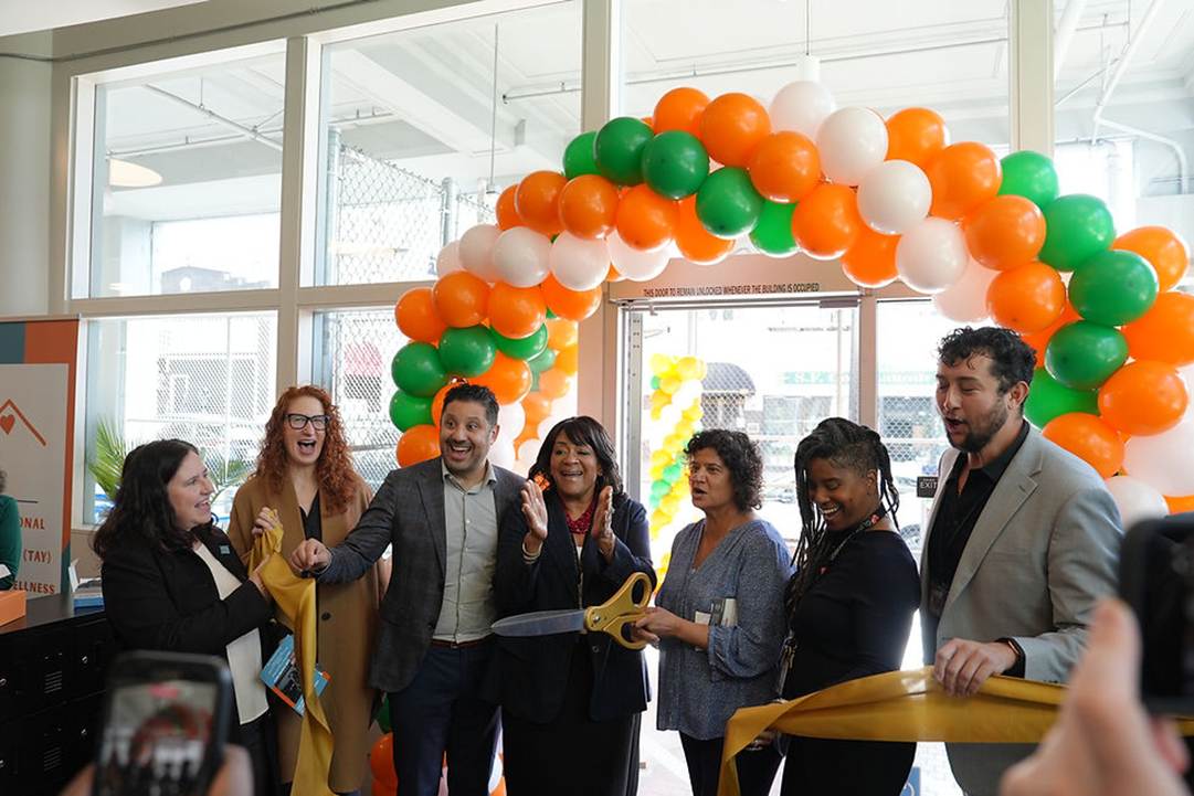 A group of people standing in a room with balloons

AI-generated content may be incorrect.