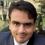 A person in a suit

AI-generated content may be incorrect.