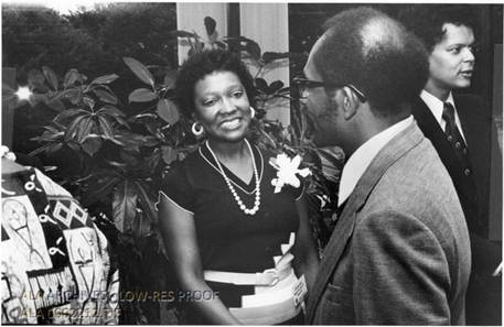 Louise Jones Giles shaking hands at a conference.