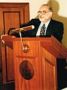 man speaking into microphone at podium