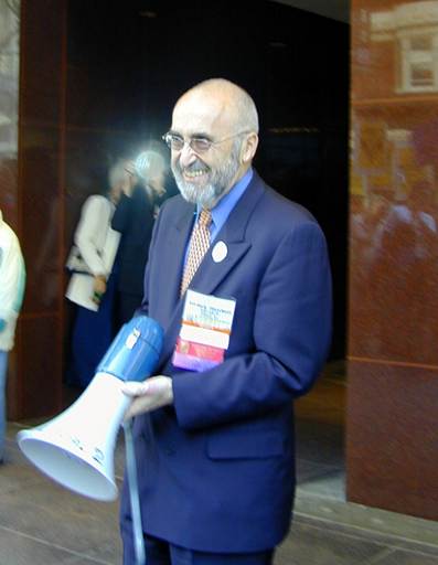 man smiling, holding megaphone