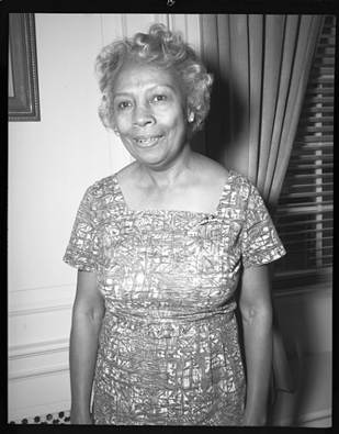 black-and-white photo of woman smiling at camera