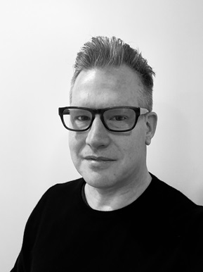 A person wearing glasses and a black shirt