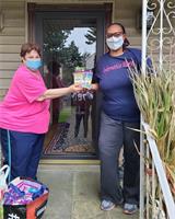 Kim Velez (Chapter Treasurer) delivering meal packets for donation to Linda DiCarlo (Chapter President-Elec