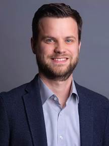 A person in a suit

AI-generated content may be incorrect.