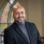 A person in a suit  AI-generated content may be incorrect.