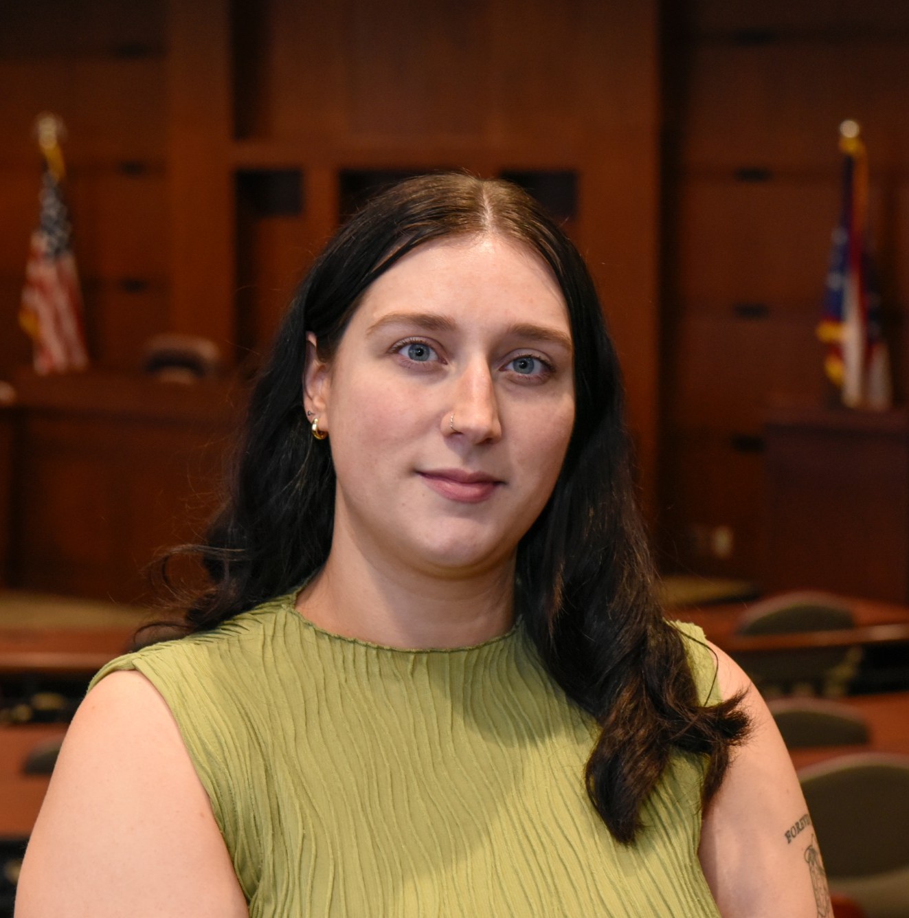 young woman with brown hair and a green shirt