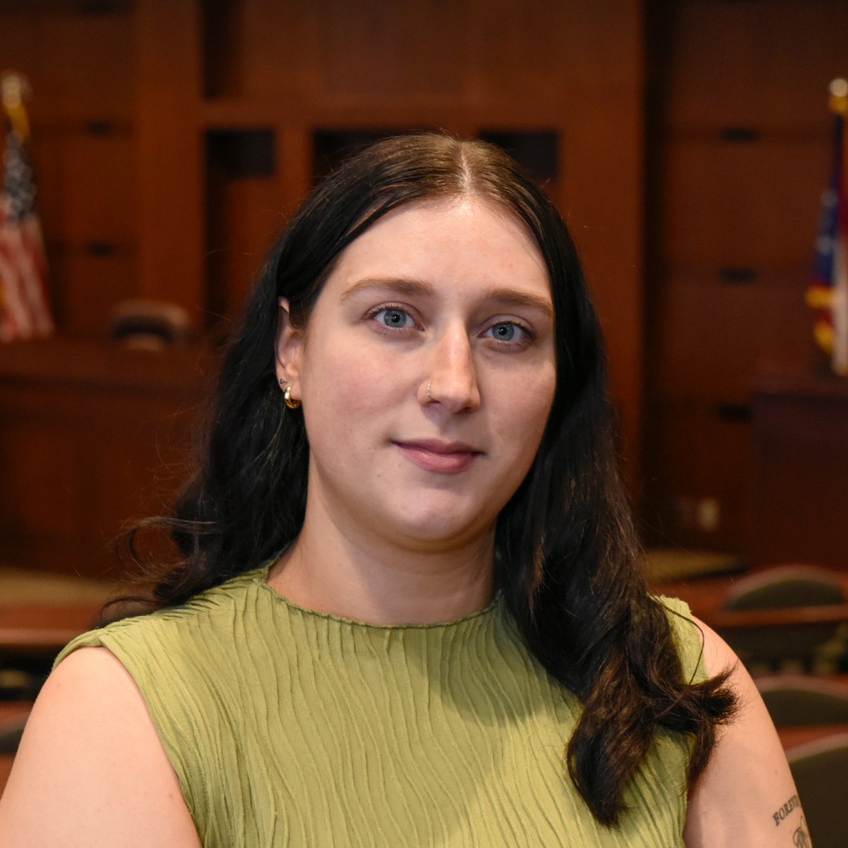 young woman with brown hair and a green shirt