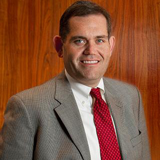 Brown hair Man smiling with a suit and tie