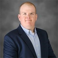 a man with a suit and tie smiling