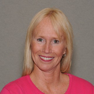 a blonde woman smiling with a red shirt