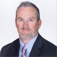 man with a beard and a suite with salt and pepper hair