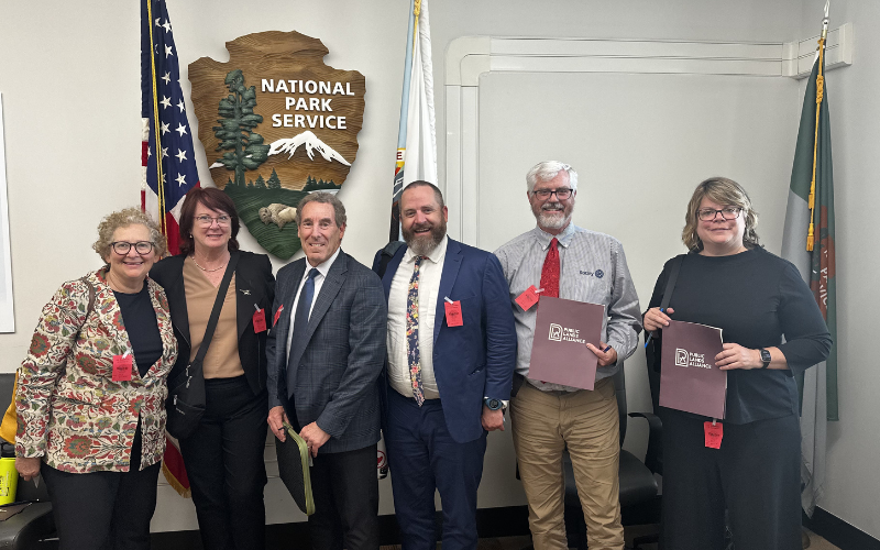 6 people standing in front of a National Park Service Sign