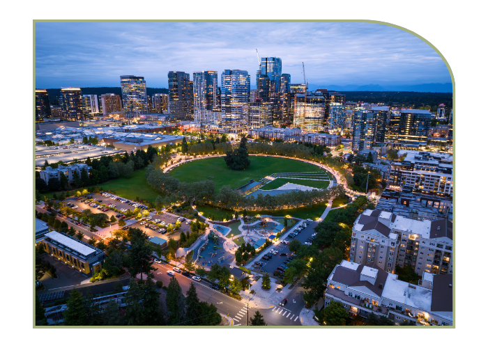 A small city at sunset with a green park in the middle