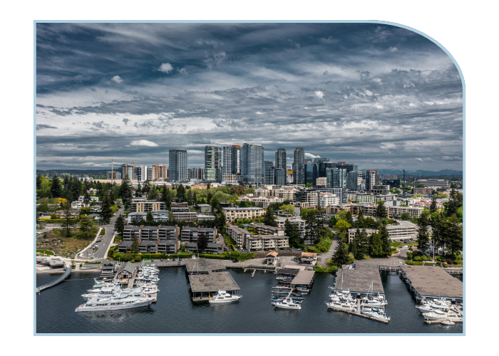 a cloudy grey small city skyline with a lake and boats at docks in the foreground