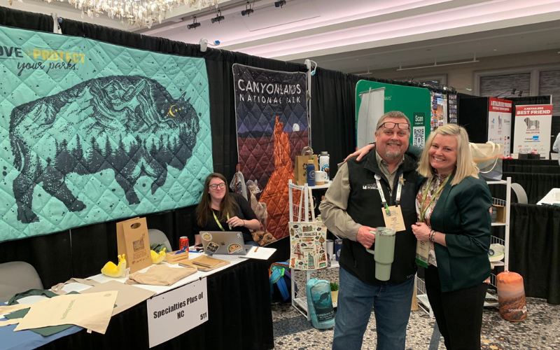 People smiling at trade show booth