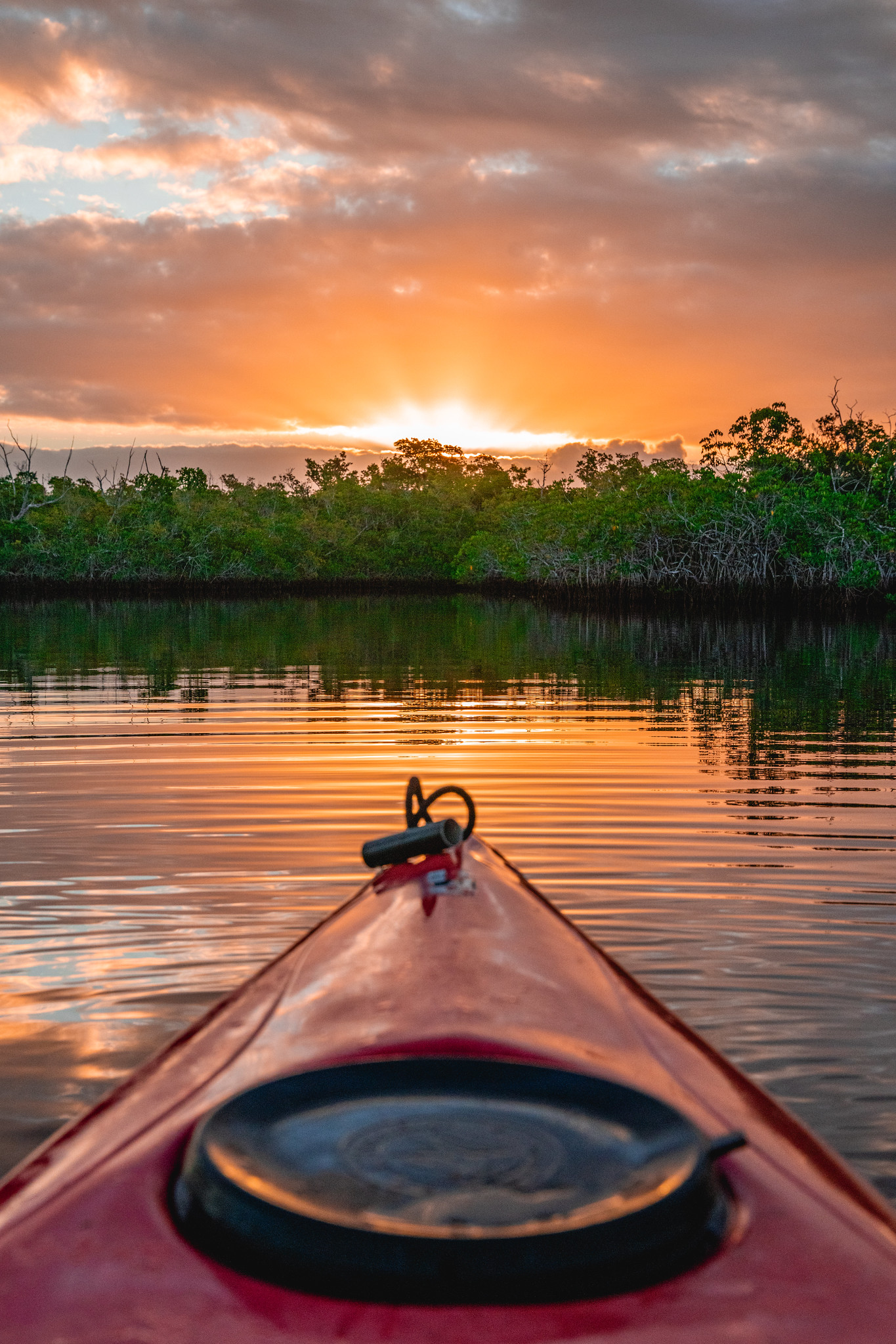 Front of a kayak at sunset