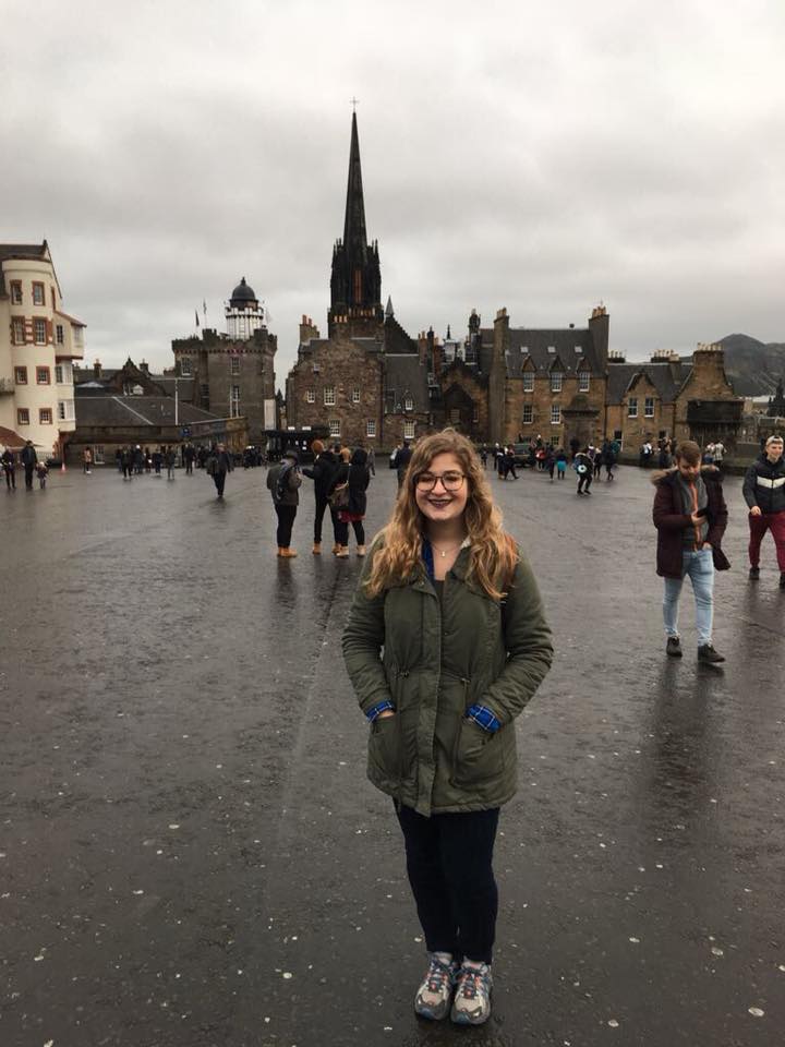 Madeleine Lerner standing in a rainy plaza in Scotland