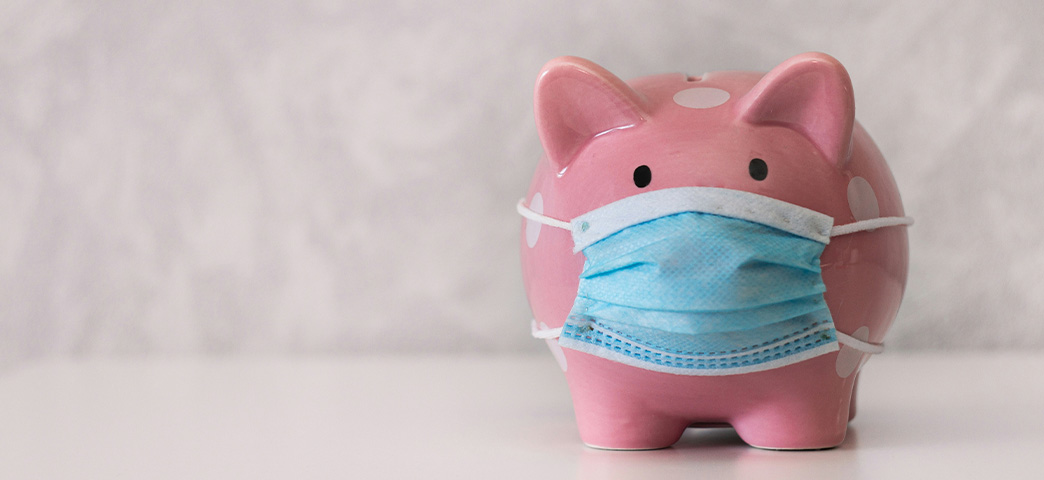 Pink piggy bank wearing a surgical mask symbolizing cost savings strategies for ambulatory surgery centers and orthopedic implant procurement