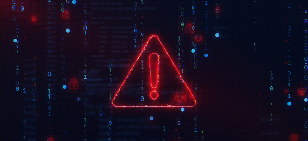 A red triangle with an exclamation point over a computer screen of code.
