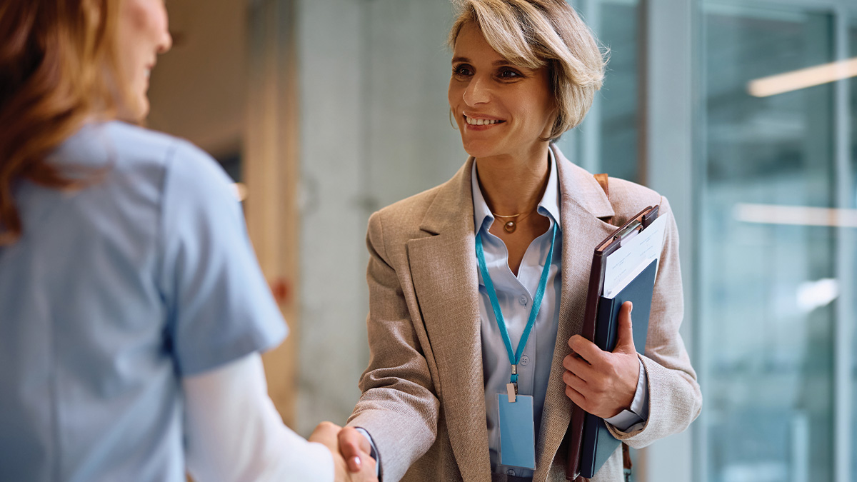 Two women shaking hands.
