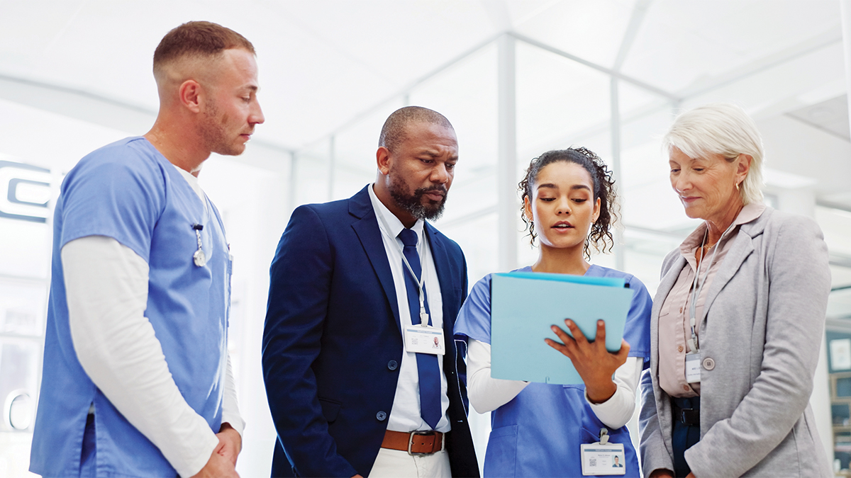 Medical professionals discussing a chart.