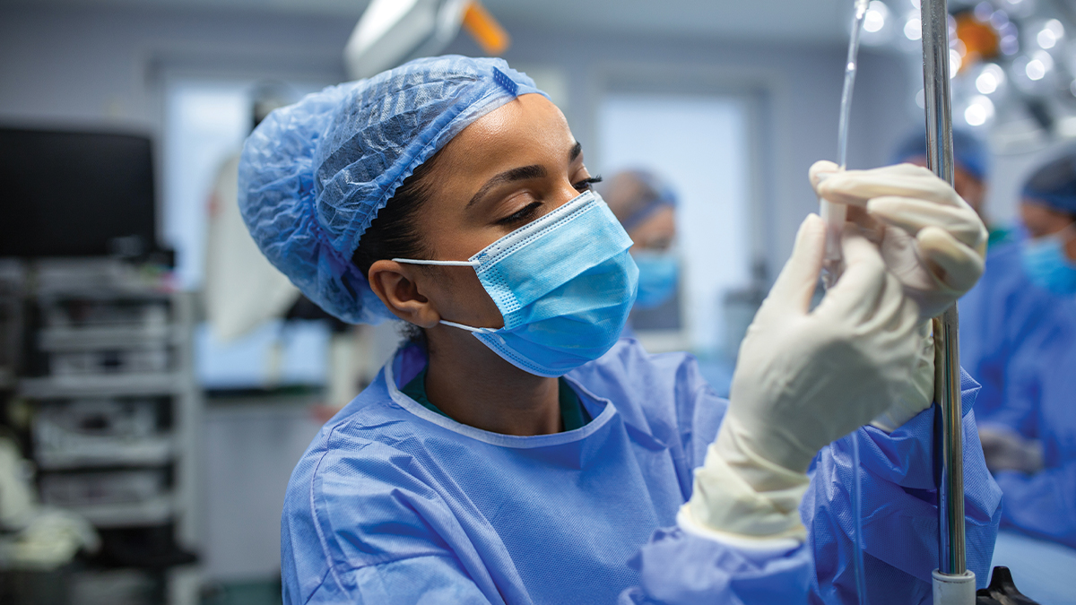 An medical professional checking a drip line.