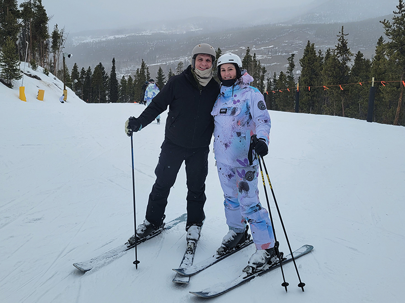Whitney and her husband skiing.