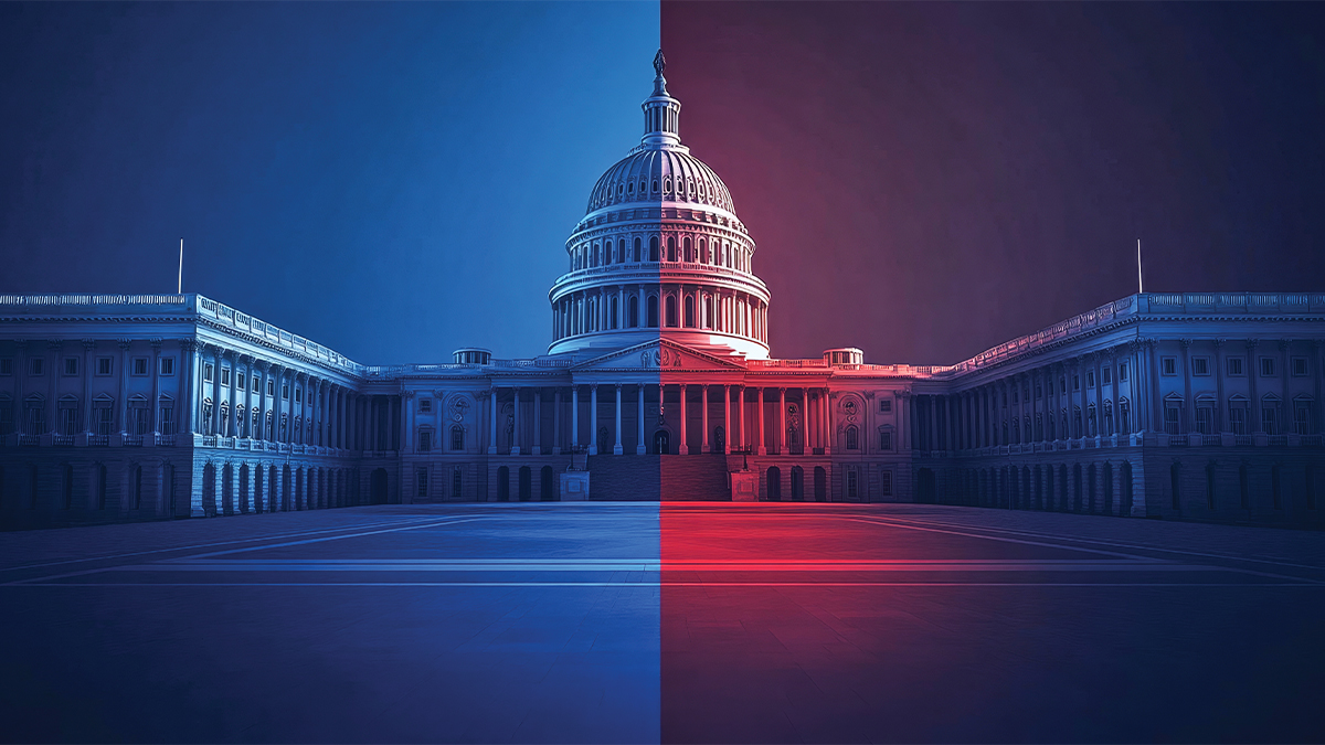 The U.S. Capitol building is dramatically lit with blue light on the left half and red light on the right, symbolizing political division between the two major parties.