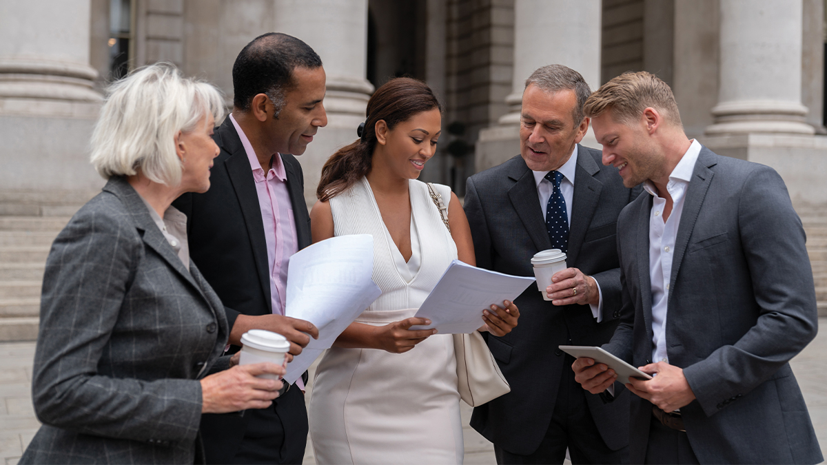 A group of people looking over a document.