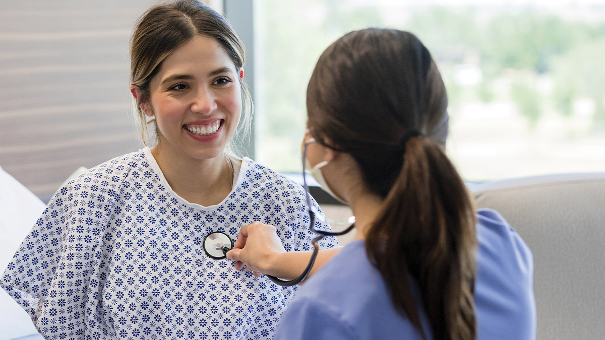 A medical professional listening to a patient's heart.