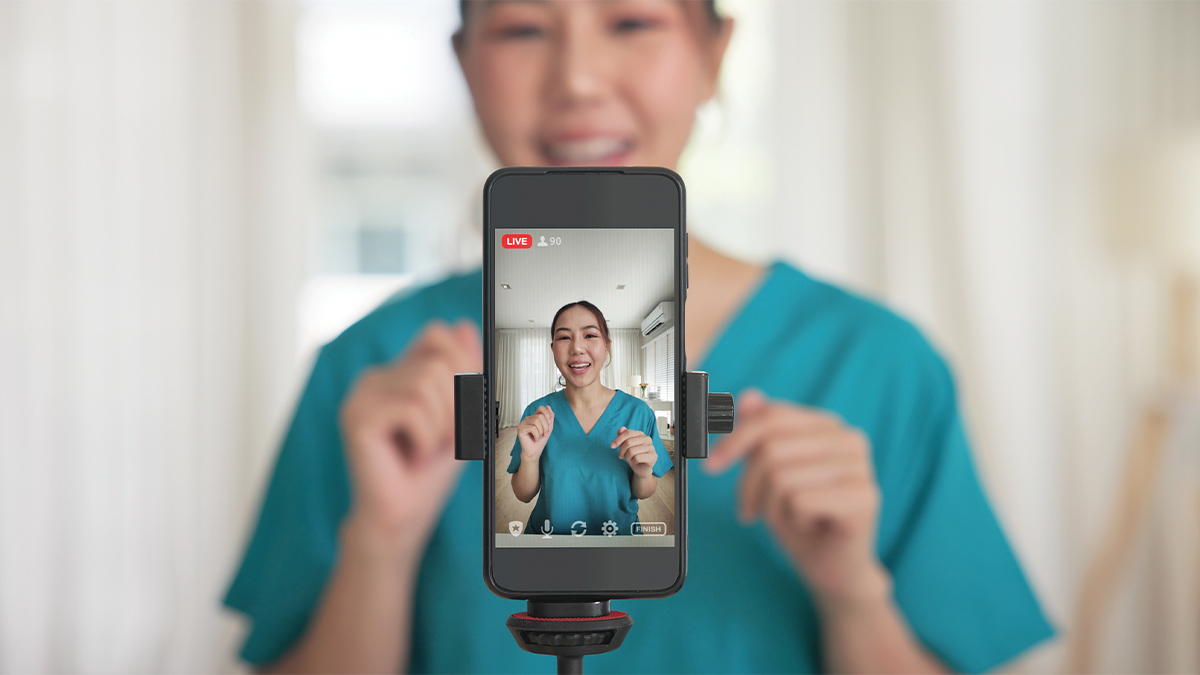 A medical professional making a video on their phone.