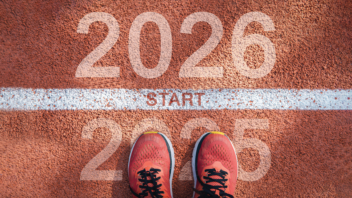 From above: feet at the starting line standing on the year 2025, across the line is 2026.