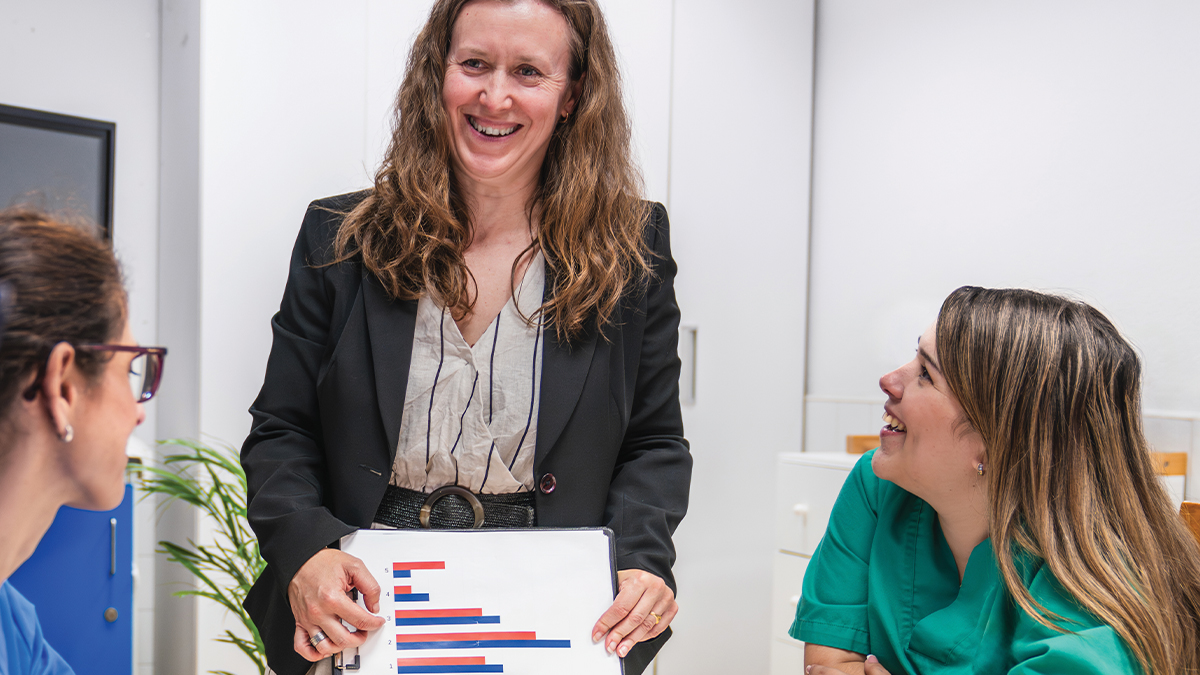 A woman showing a bar graph during a meeting.