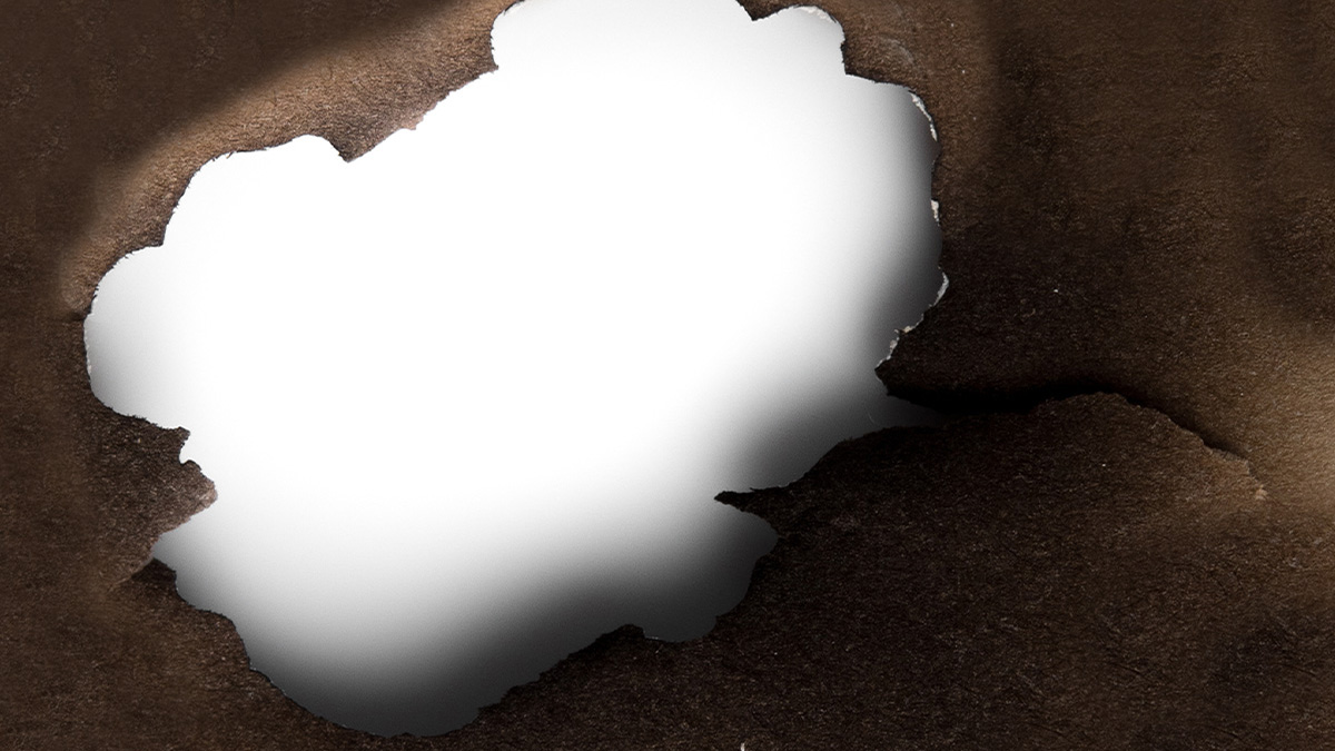 The words "Prevent staff burnout" displayed over a torn, scorched piece of paper on a white background.